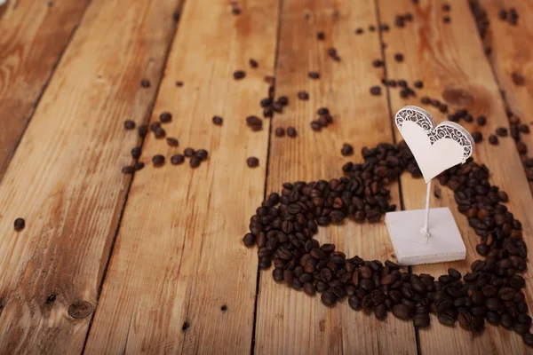 heart and coffee on a wooden table as background