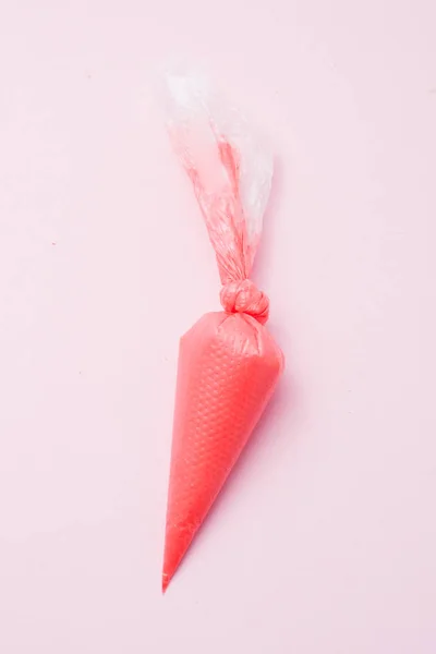 Close Colored Piping Bag Red Frosting Pink Background Top View — Stock Photo, Image