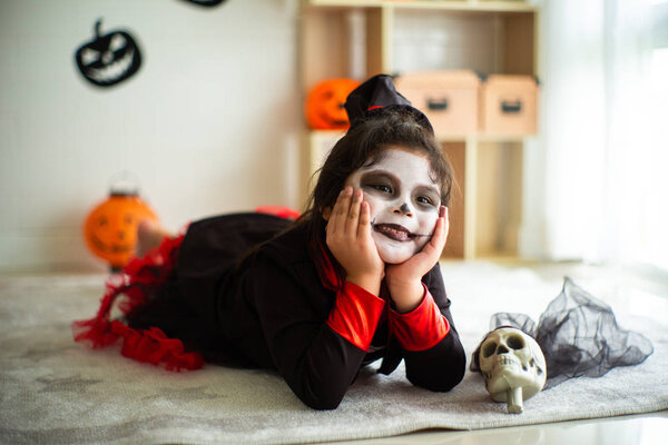 Portrait Asian little girl in Halloween costume smiling to the camera