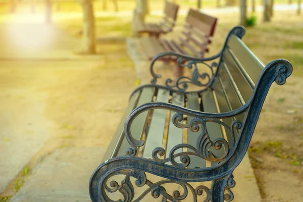 Closeup Rusted Steel Vintage Bench Blurred Wooden Benches Background Outdoor — Stock Photo, Image