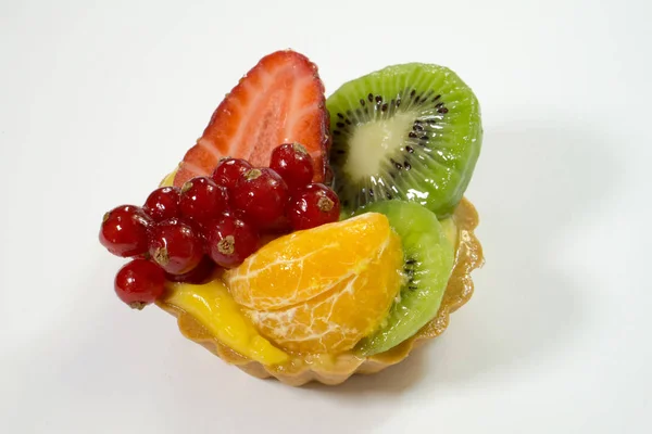Cake with fresh bio fruits, orange, kiwi, red currants, strawberries, side view photo, white background, isolate
