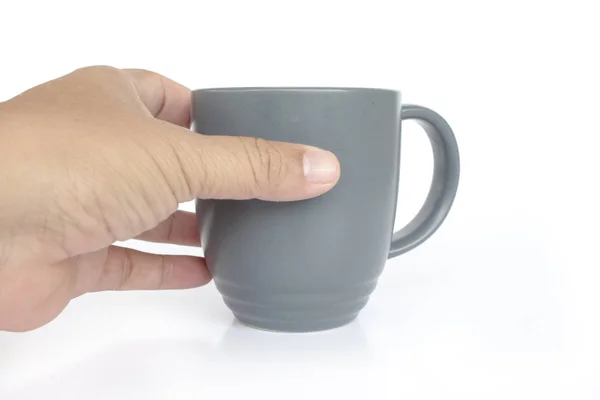 Mano sosteniendo taza de café gris sobre fondo blanco — Foto de Stock