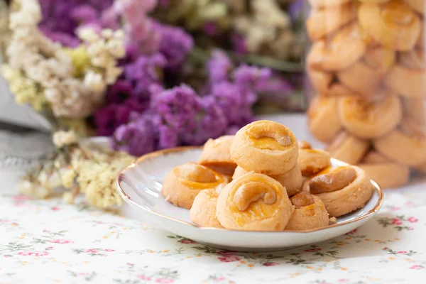 Cookies Singapore or cashew Cookies with dried vintage flower on vintage background.