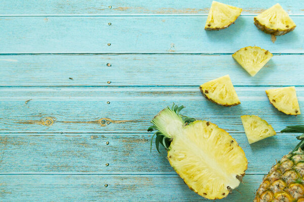 Ripe pineapples summer tropical fruits on pastel turquoise background. Summer fruit concept.