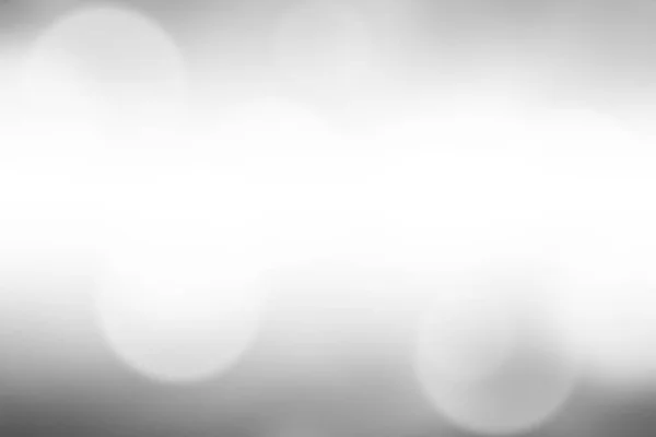 Blurred light gray gradient bokeh abstract background.