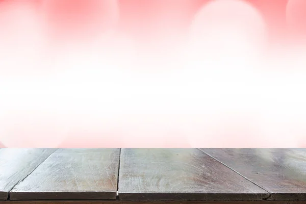 Empty desk with blurred light red gradient bokeh abstract background.