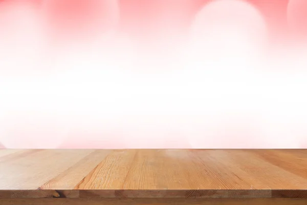 Empty desk with blurred light red gradient bokeh abstract background.
