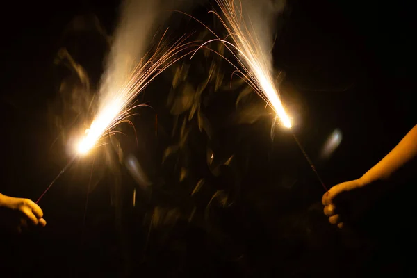 Blurred New Year Party Burning Sparkler Kids Hand Black Background — Stock Photo, Image