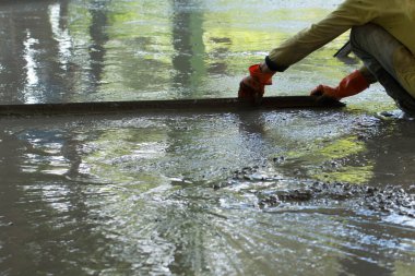 İnşaat işçisi beton döşeme döşüyor, inşaat işçileri ile inşaat, ev inşa konsepti..
