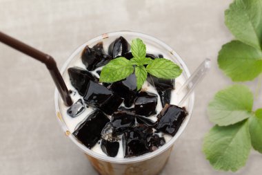 Taze sütle çimen jölesi ve plastik bardakta karamel..