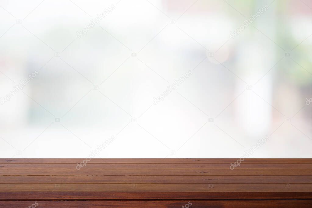 Wooden desk with Abstract blurred outdoor for background.