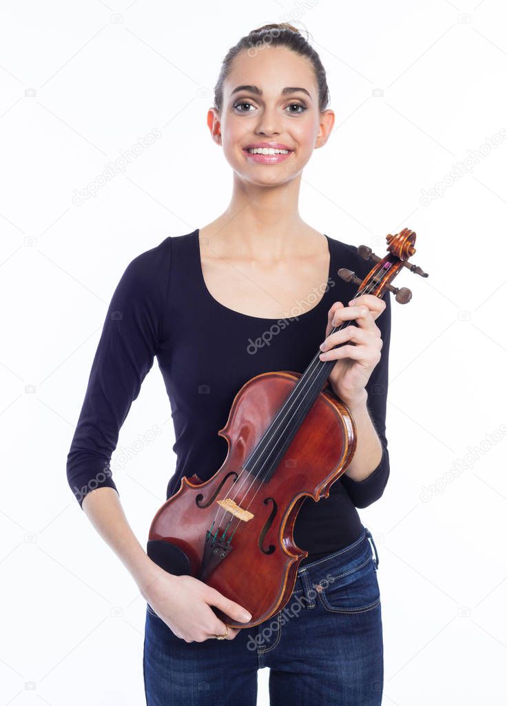 Portrait of beautiful young woman holding violin and smiling at camera. Studio shot, white background.