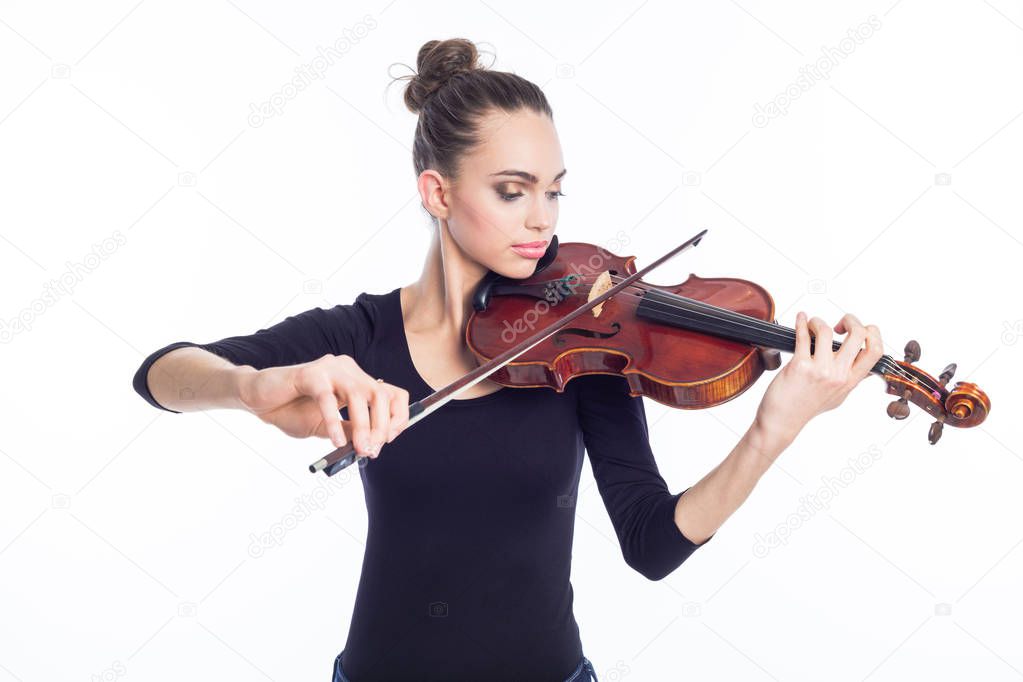 Portrait of beautiful young woman playing violin. Studio shot, white background.