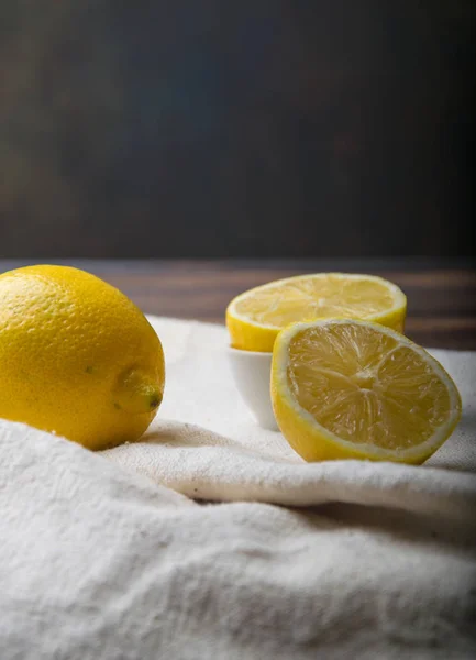lemons in a cut on a wooden tabletop