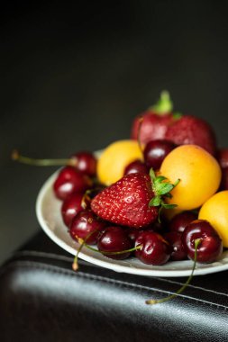 fruits and berries on a plate close-up