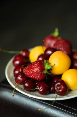  a variety of fruits and berries on a plate