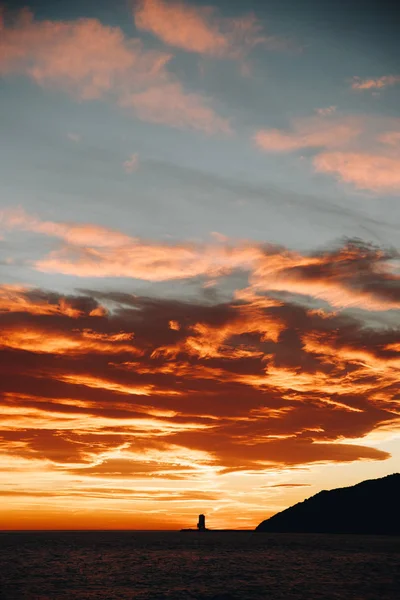 Sunset sky with red clouds in the beach