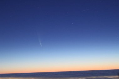 View of the C/2020 F3 (NEOWISE) comet above the clouds clipart