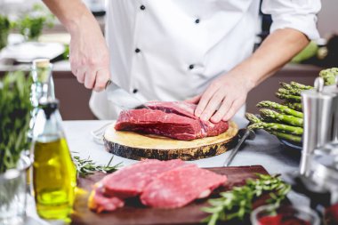 Yemek restoran mutfak şefi, o et veya biftek kesiyor 