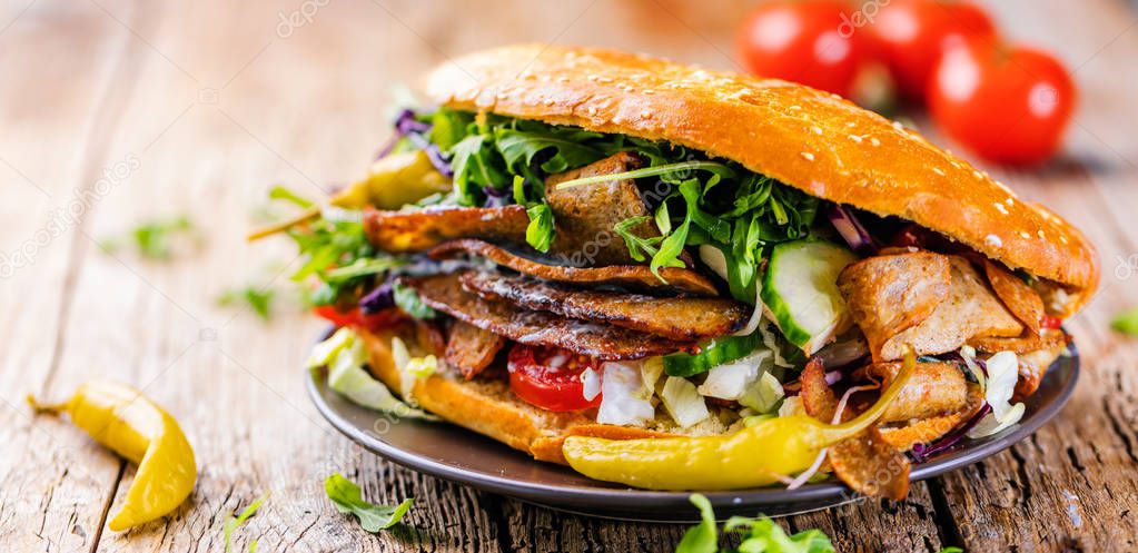 Delicious kebab sandwich on wooden background