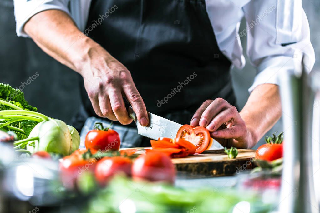 Chef cook preparing vegetables in his kitchen