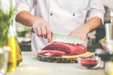 Yemek restoran mutfak şefi, o et veya biftek kesiyor 