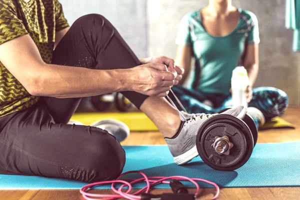 Woman and man having functional fitness training in sport gym