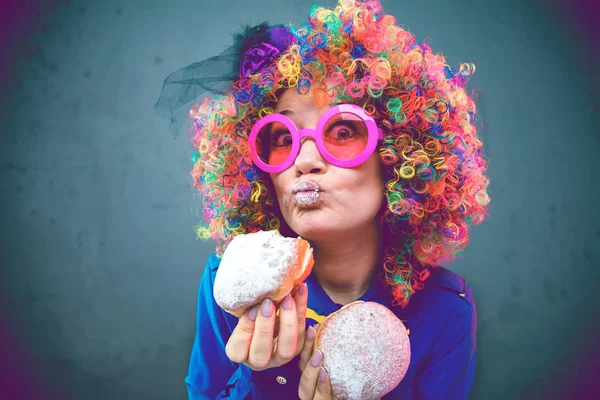 happy woman wearing color wig with party items