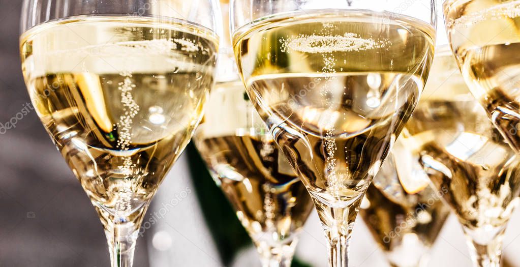 Champagne glasses close up, party background