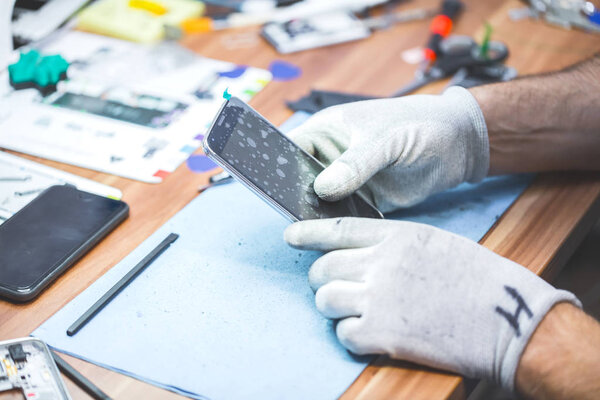 Close-up photos showing process of mobile phone repair