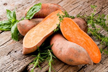 Sweet potato on wooden background  clipart