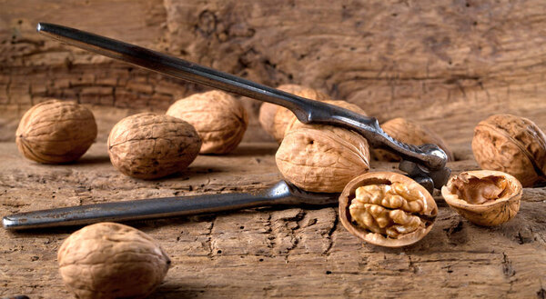 Walnut kernels on rustic old oak table.
