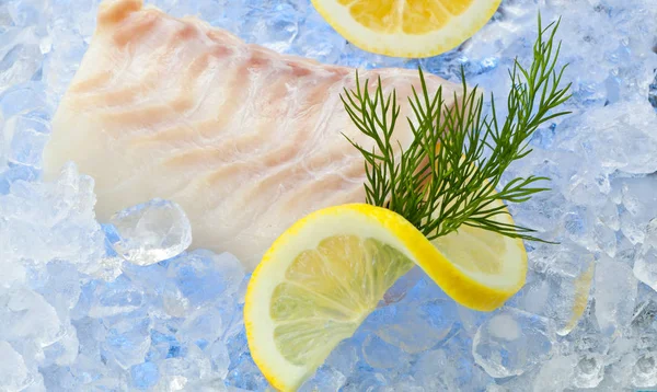 Cod fish fillets on ice with fresh Lemon