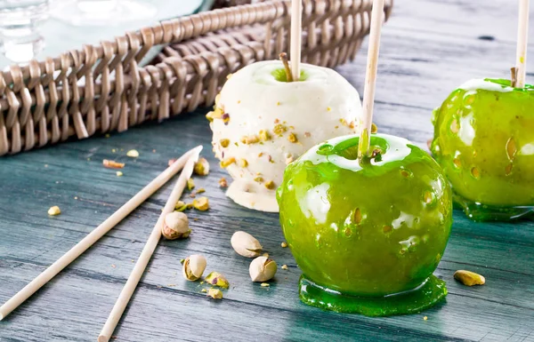 Table with colored candy apples