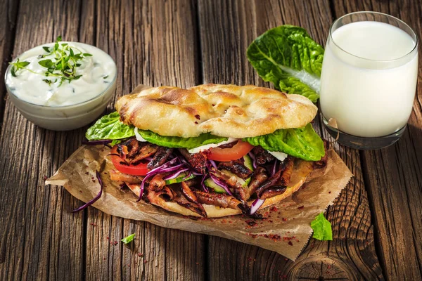 close up of kebab sandwich on wooden background