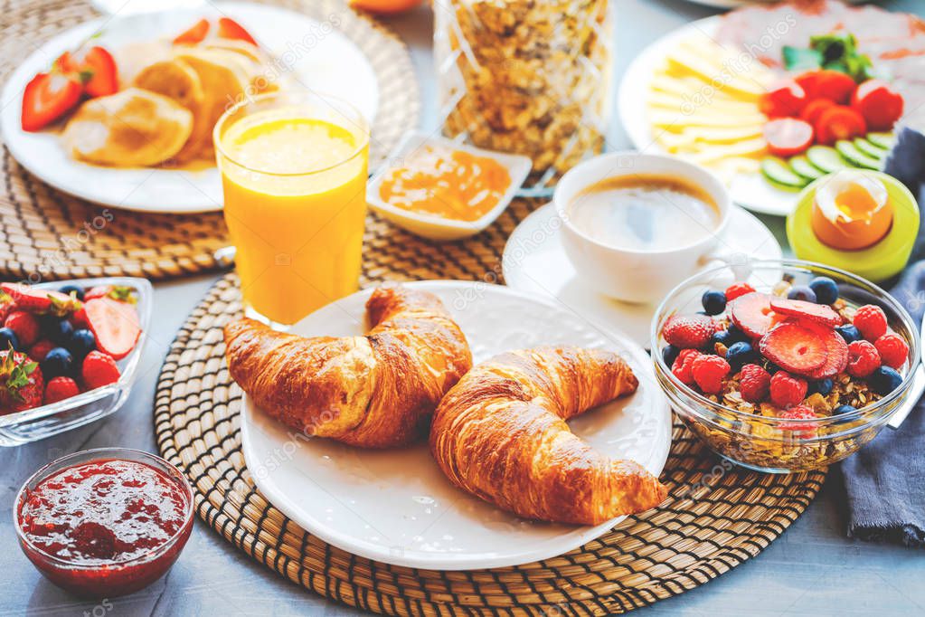 Breakfast served with coffee, orange juice, croissants, cereals and fruits. Balanced diet.