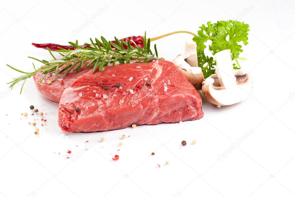 beef steaks with spices isolated on white background