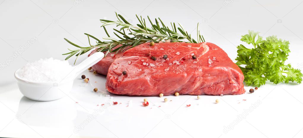 beef steaks with spices isolated on white background