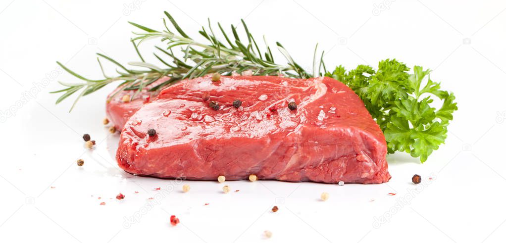 beef steaks with spices isolated on white background