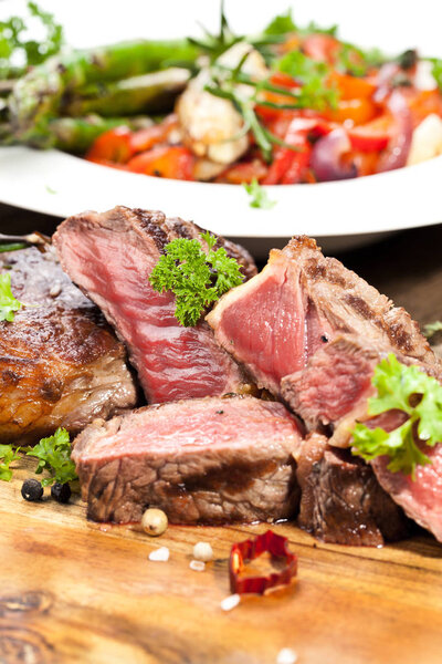 Grilled ribeye beef steak, herbs and spices. Top view