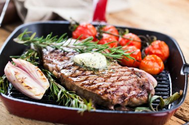 Izgara siyah Angus biftek kızartma koyu arka plan üzerinde dökme demir ızgara tava üzerinde Striploin