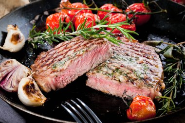 Izgara siyah Angus biftek kızartma koyu arka plan üzerinde dökme demir ızgara tava üzerinde Striploin