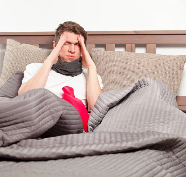 Man feeling bad lying in the bed and coughing