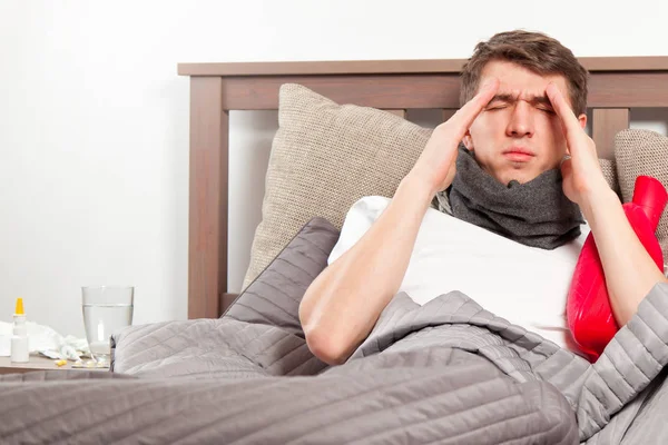 Man feeling bad lying in the bed and coughing