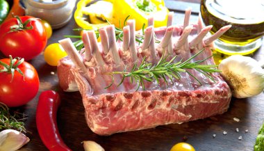 Rack of lamb , raw meat with bone on rustic kitchen table at wooden background clipart