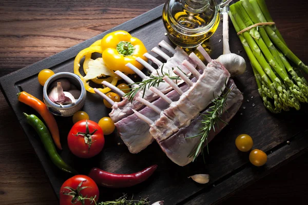 Kuzu raf, ahşap arka plan rustik mutfak masasında kemiği ile çiğ et