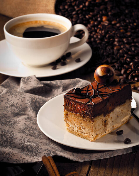 cup of coffee and  cake on coffee beans.