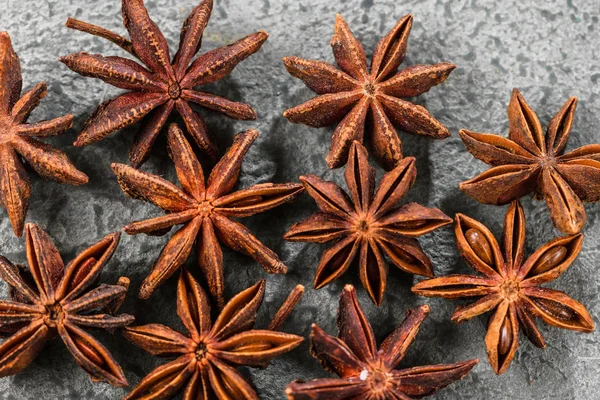 Anise stars closeup against dark rustic wooden background