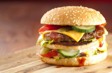 Fast food hamburger ve kızarmış patates ahşap arka plan üzerinde