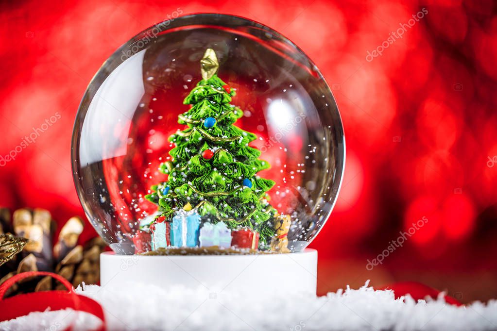 Christmas snow globe on wooden background